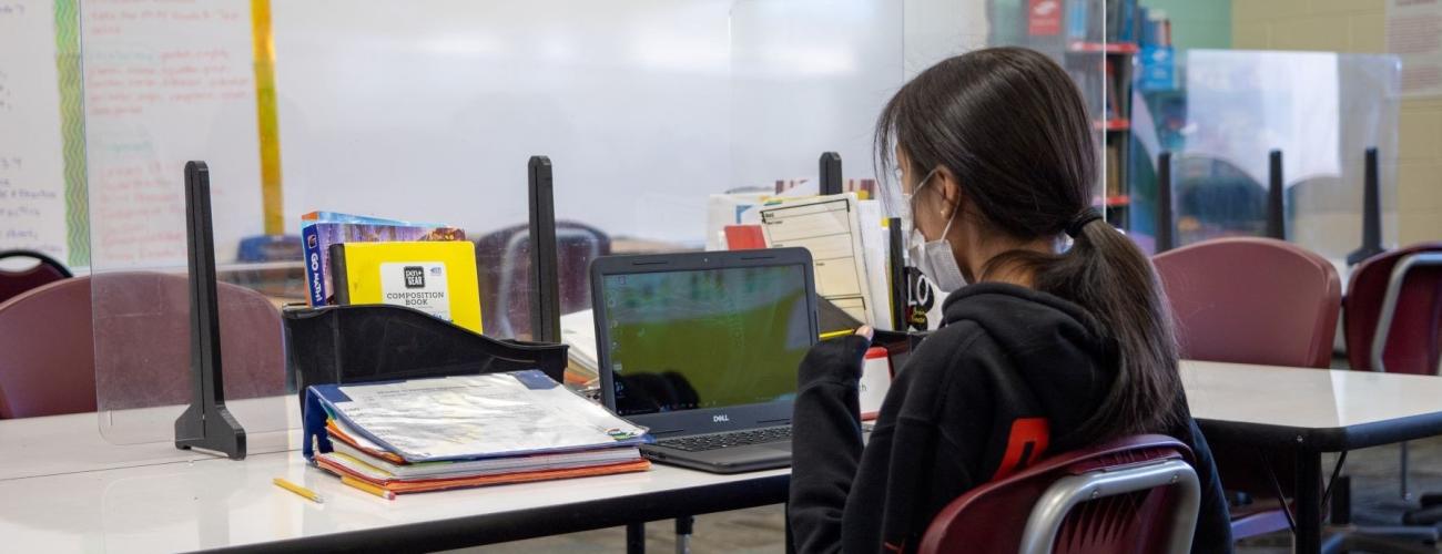 student on laptop in classroom